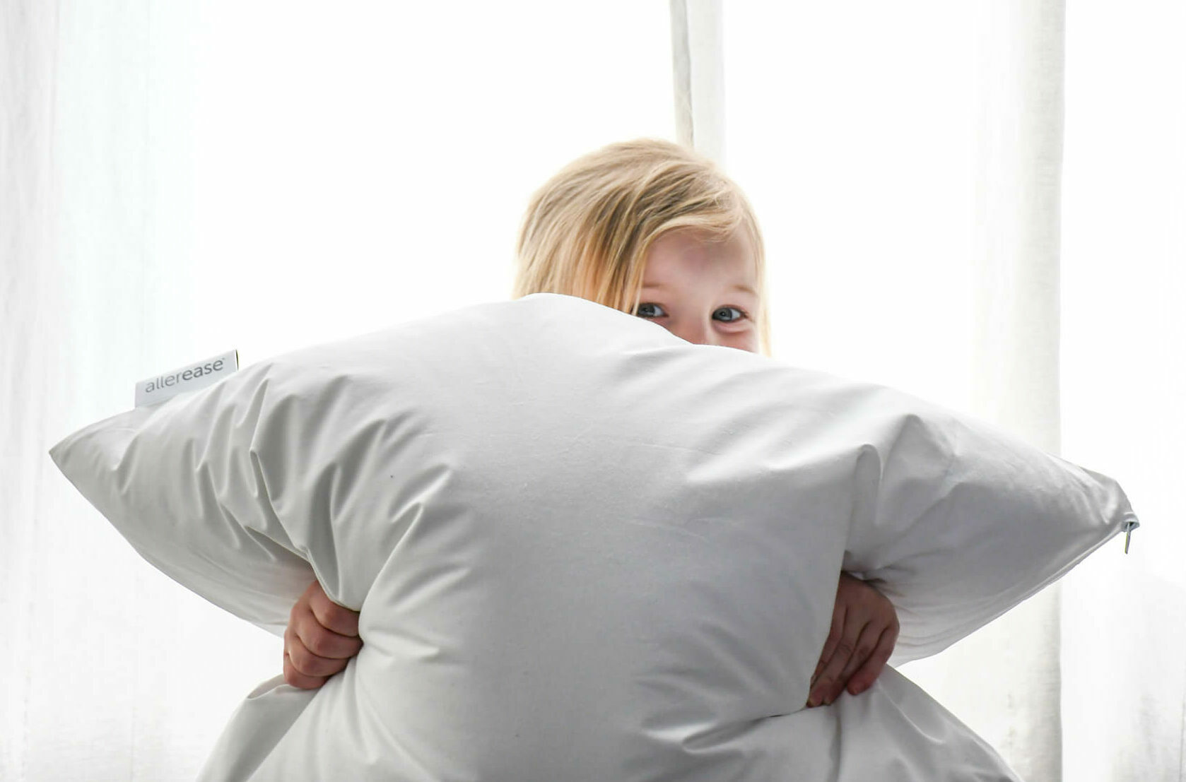 Kid squeezing a pillow.