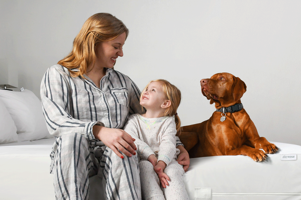 Woman, child, and dog on allerease bed